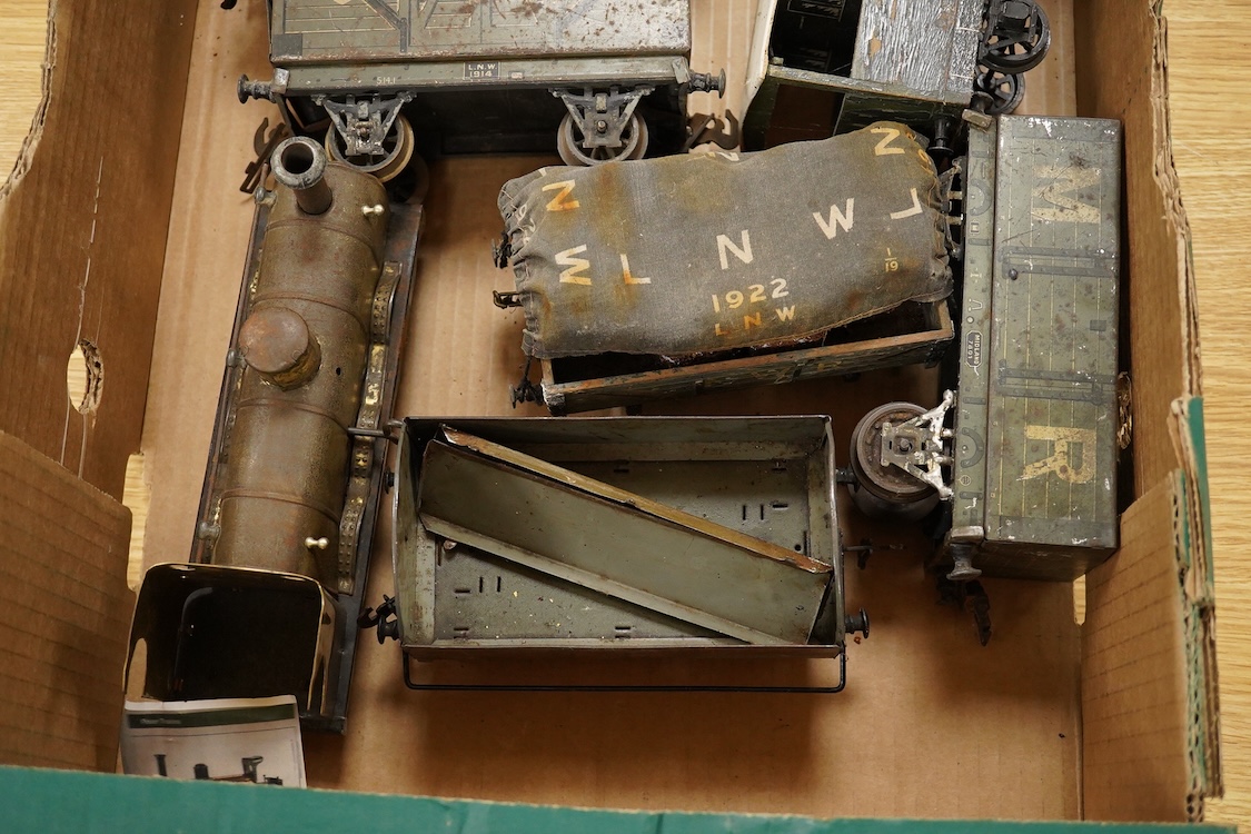 Seven Gauge One coarse scale railway freight wagons, by Bassett-Lowke, etc., including tinplate and wooden examples in liveries for LNWR, Midland Railway, and LBSCR, together with the remains of a scarce late 19th centur